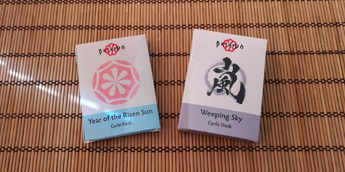 An image of the original Bushido Year of the Risen Sun and Weeping Sky deck packs.