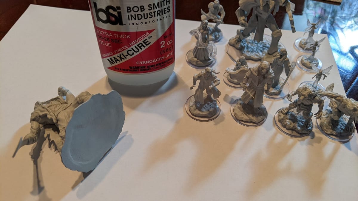 A photo of minis being assembled and the warping on the base