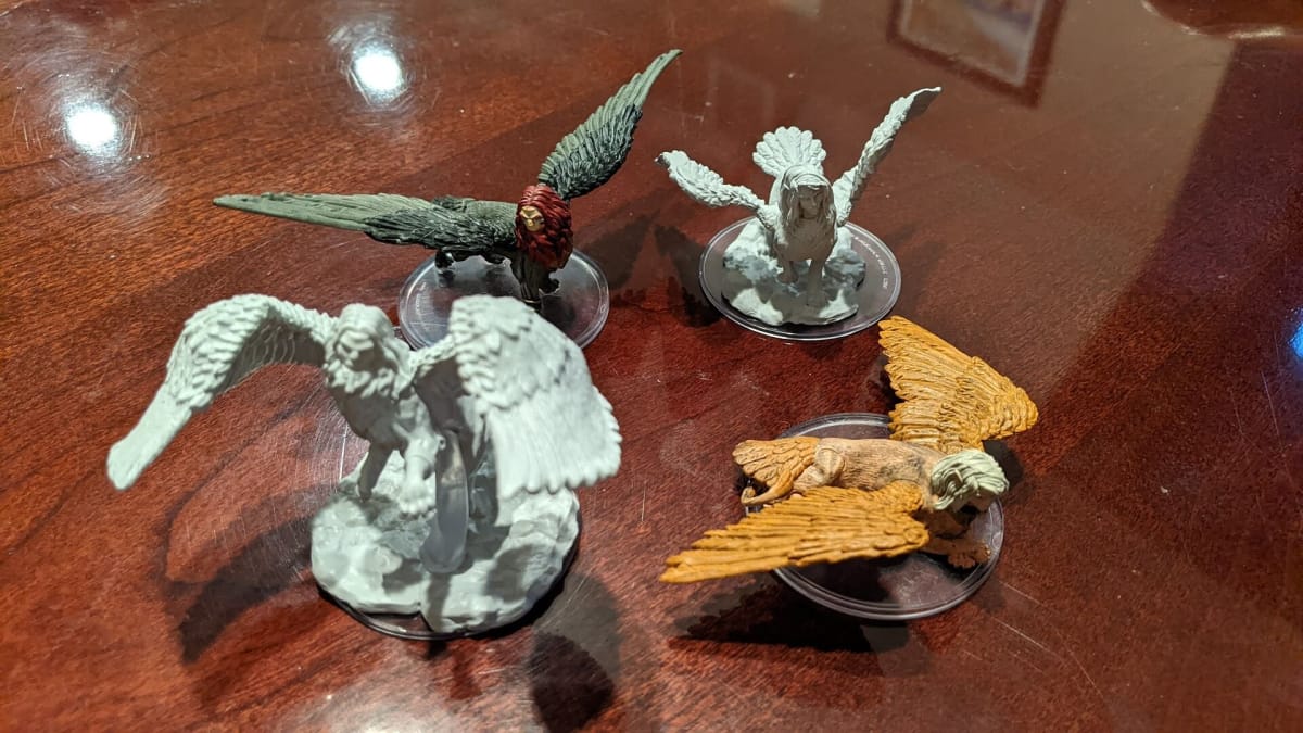 Comparison photo of the painted minis vs the unpainted minis and the differences in their poses