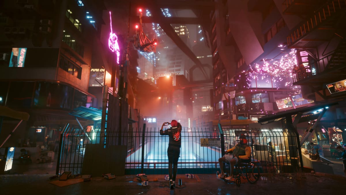 A citizen of Night City makes a heart shape with their hands amid towering neon blocks and buildings in Cyberpunk 2077