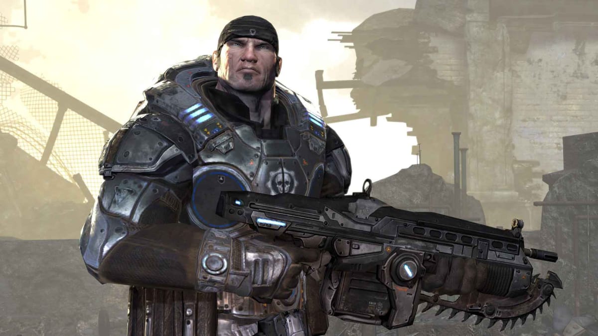 A large stocky man in combat armour wearing a black bandana holding a large rifle with a saw attachment, stood in front of the rubble of a destroyed building.