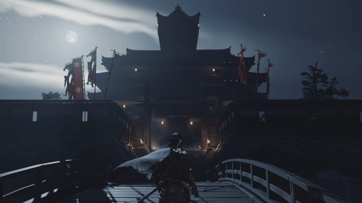 Jin stands before a grand castle in Ghost of Tsushima