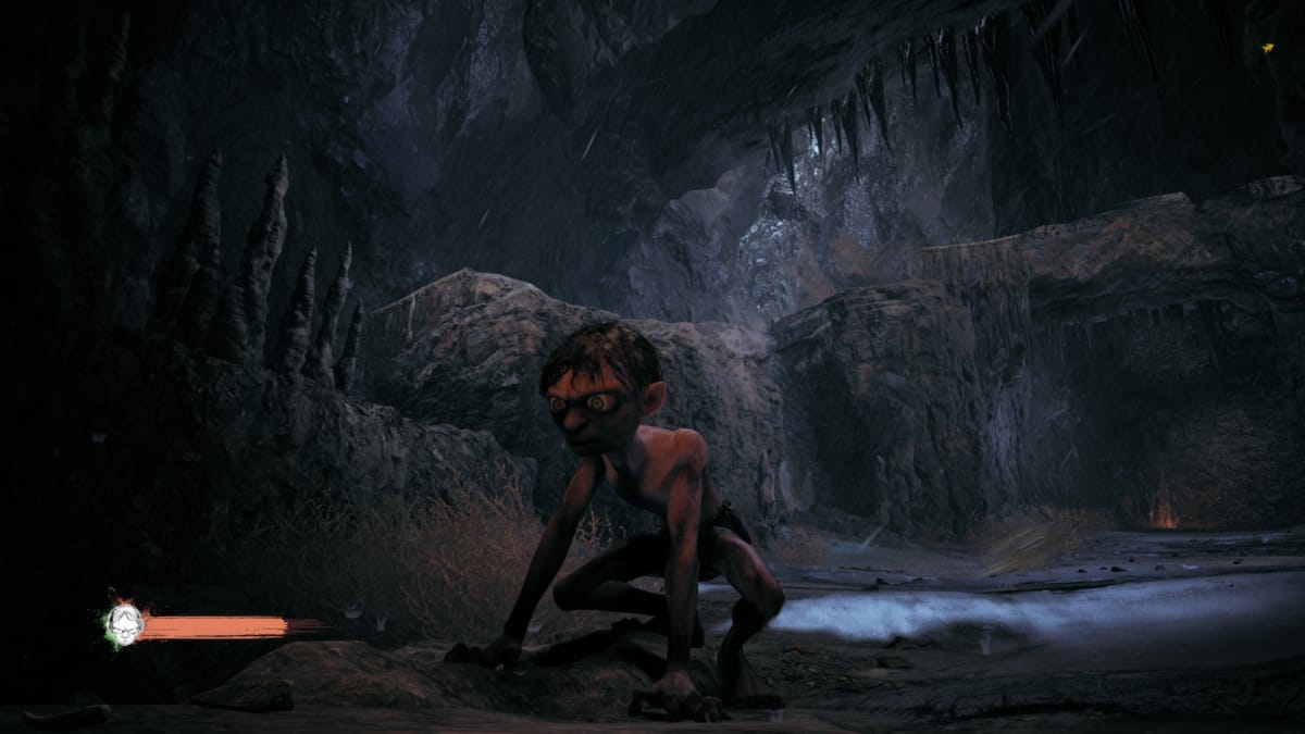 Gollum screenshot showing gollum staring into a dark corner with craggy mountains behind him. 