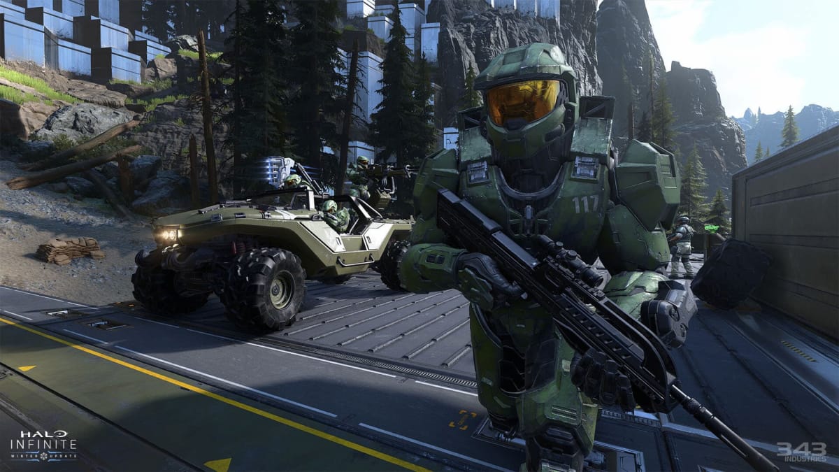 Halo Infinite Winter update screenshot of the player holding a large weapon with a scope running through the mountains map, Halo Infinite December update