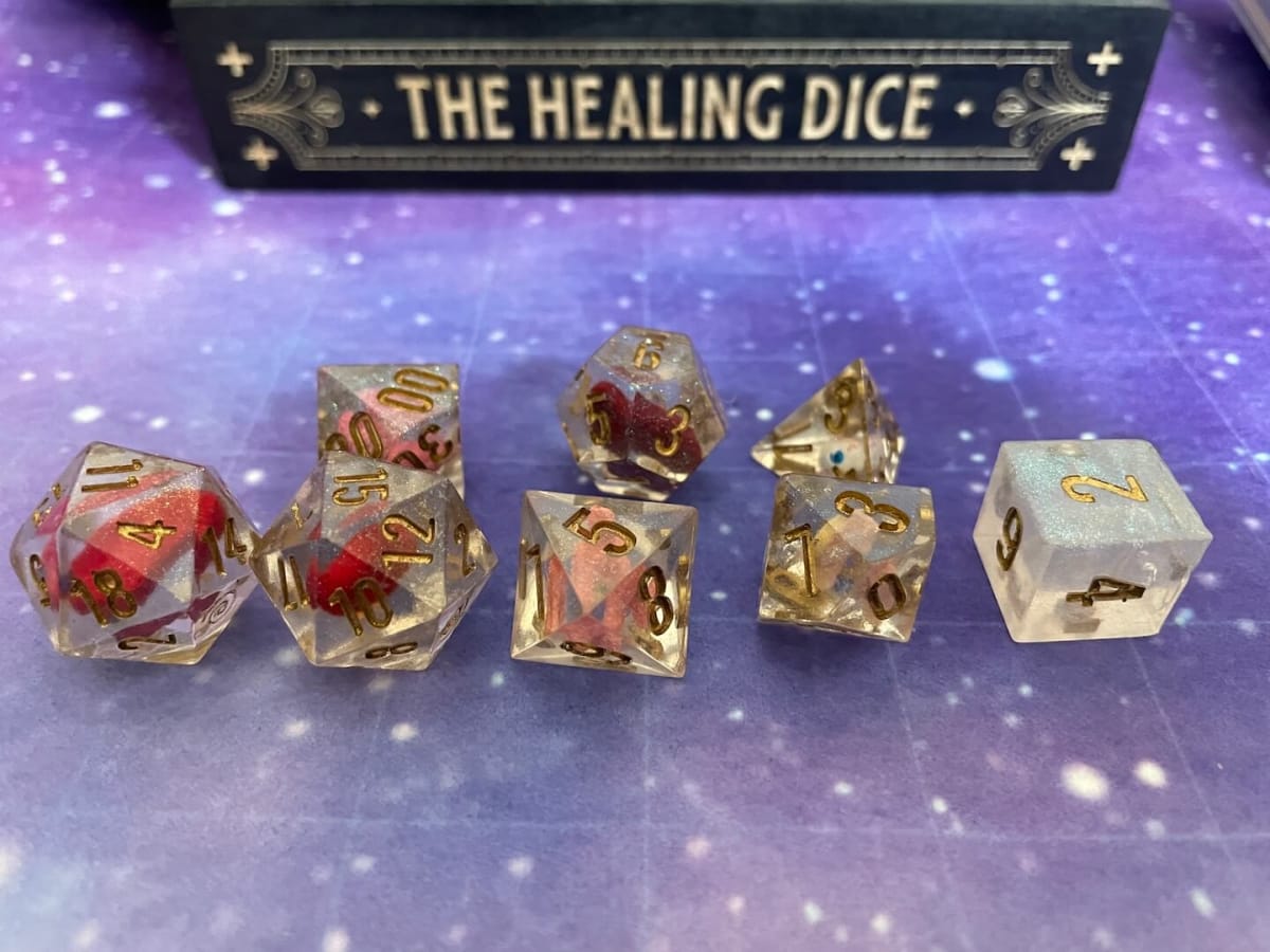 A photo of the healing dice against a starry background