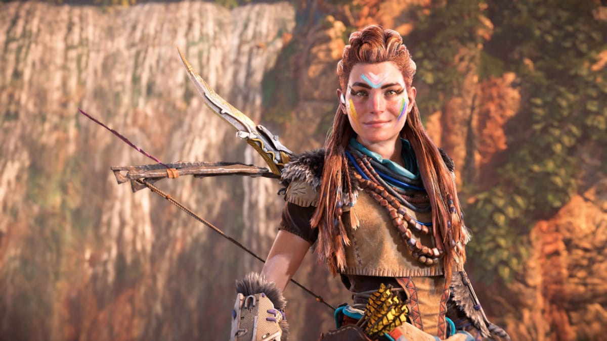 Aloy wearing the Mark of Pride flag face paint and smiling in Horizon Forbidden West