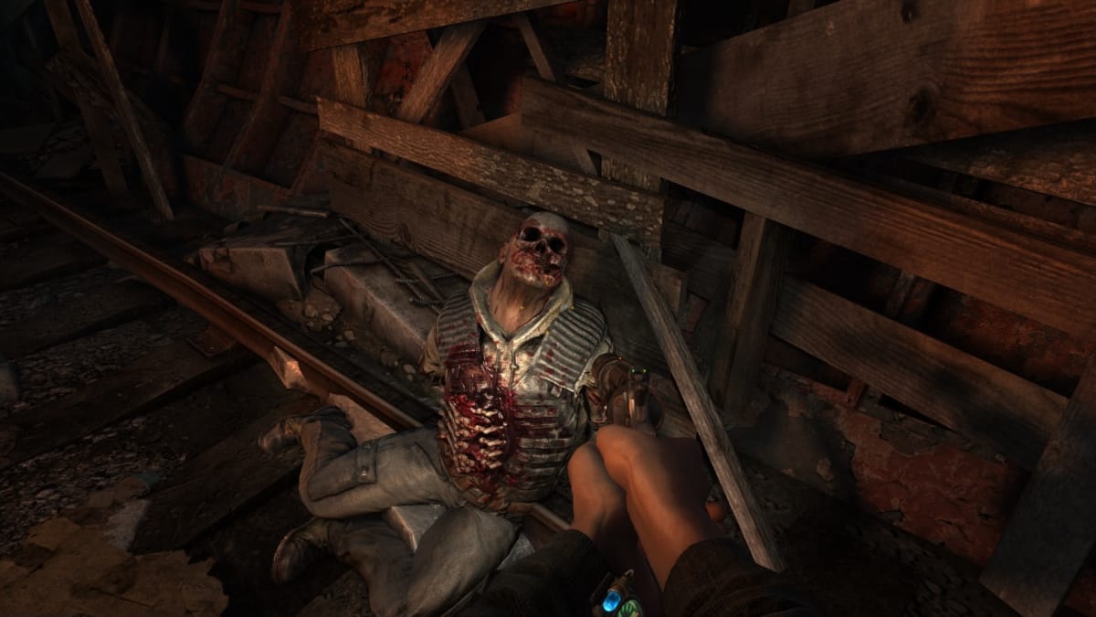 Metro 2033 Redux screenshot showing a mutilated corpse in an underground rail tunnel. 