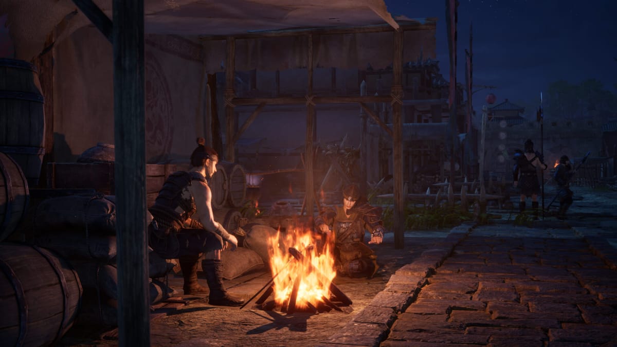 Two characters sit around a fire in Myth of Empires