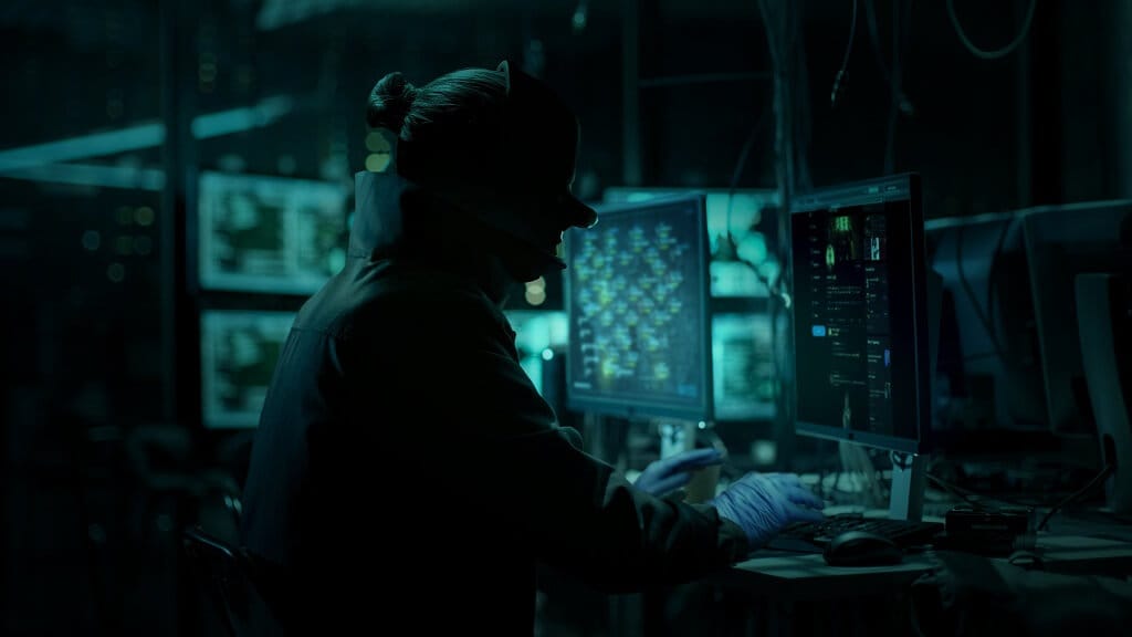 A hacker working on a computer in Payday 3