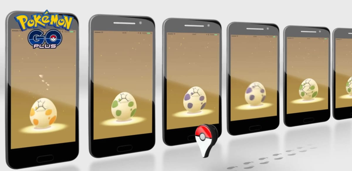 A Pokemon Go Plus accessory walking along while eggs hatch in the background