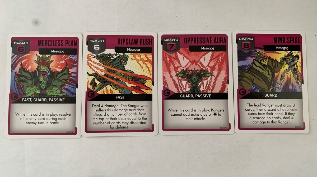 A spread of Mesogog's cards from Villain Pack 4