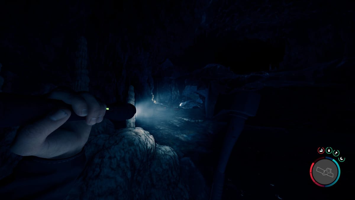 Character holding torch in Sons of the Forest, looking towards another cave tunnel