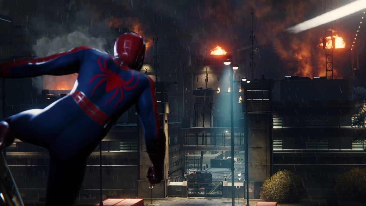 Spider-Man springs into action in front of a burning building.