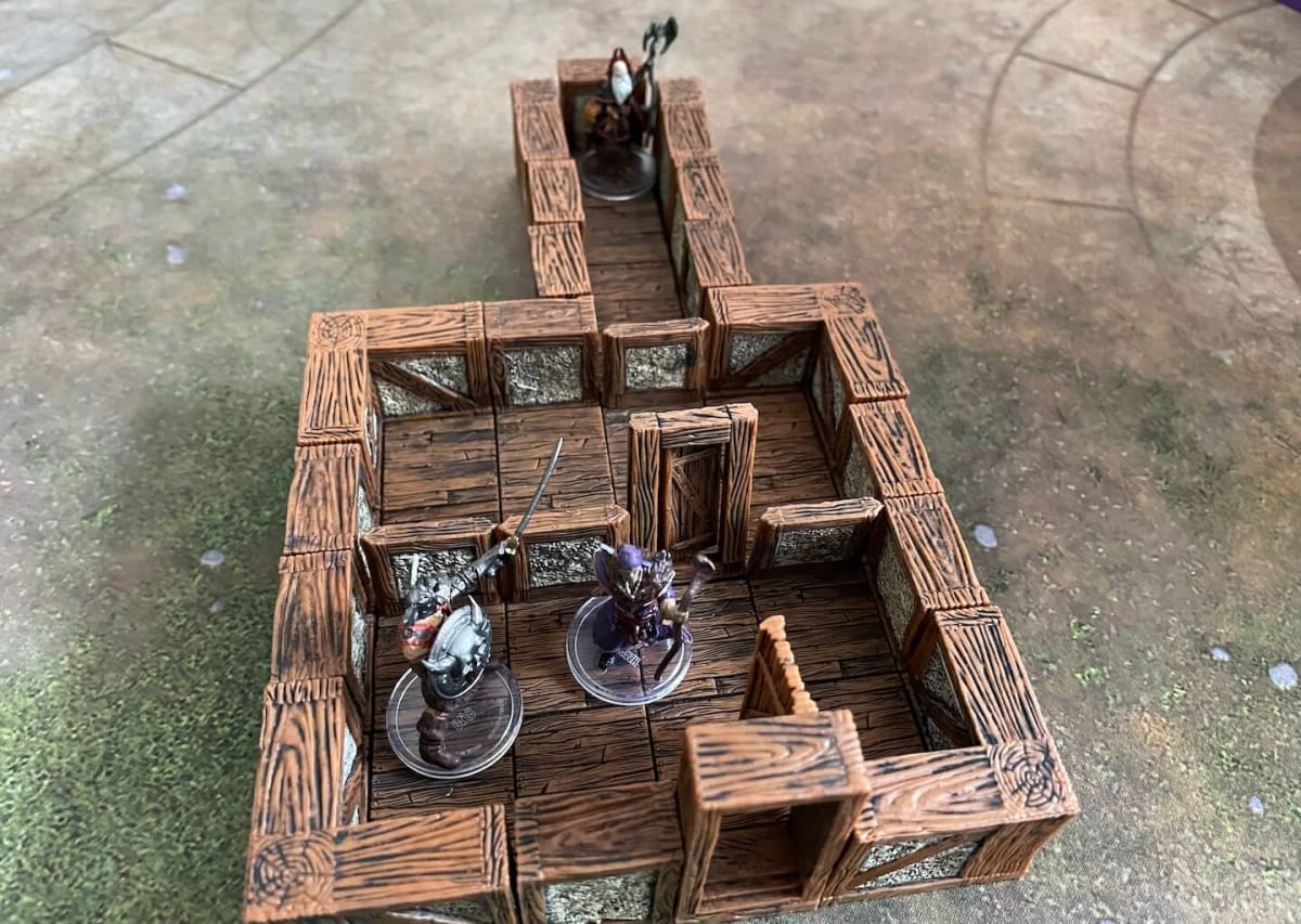 A Wizard hides in a secret room at the back of the tavern created with WizKids WarLock Dungeon Tiles.