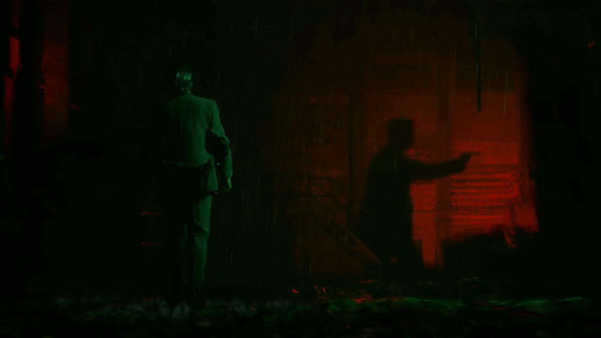 Alan Wake lit in green with a red light in the background casting the shadow of a person holding a gun.