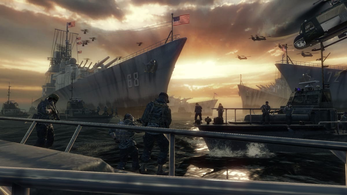 An in-game screenshot of Call of Duty: Black Ops, showcasing the player-character surrounded by several soldiers, boats, naval fleets, and airplanes underneath a sunset.