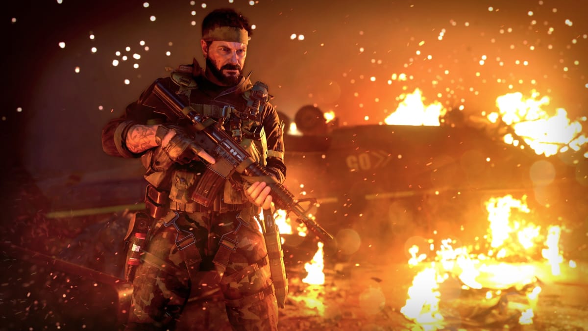 An in-engine screenshot of Call of Duty: Black Ops Cold War, showcasing the side character Woods standing in front of a ruined helicopter.