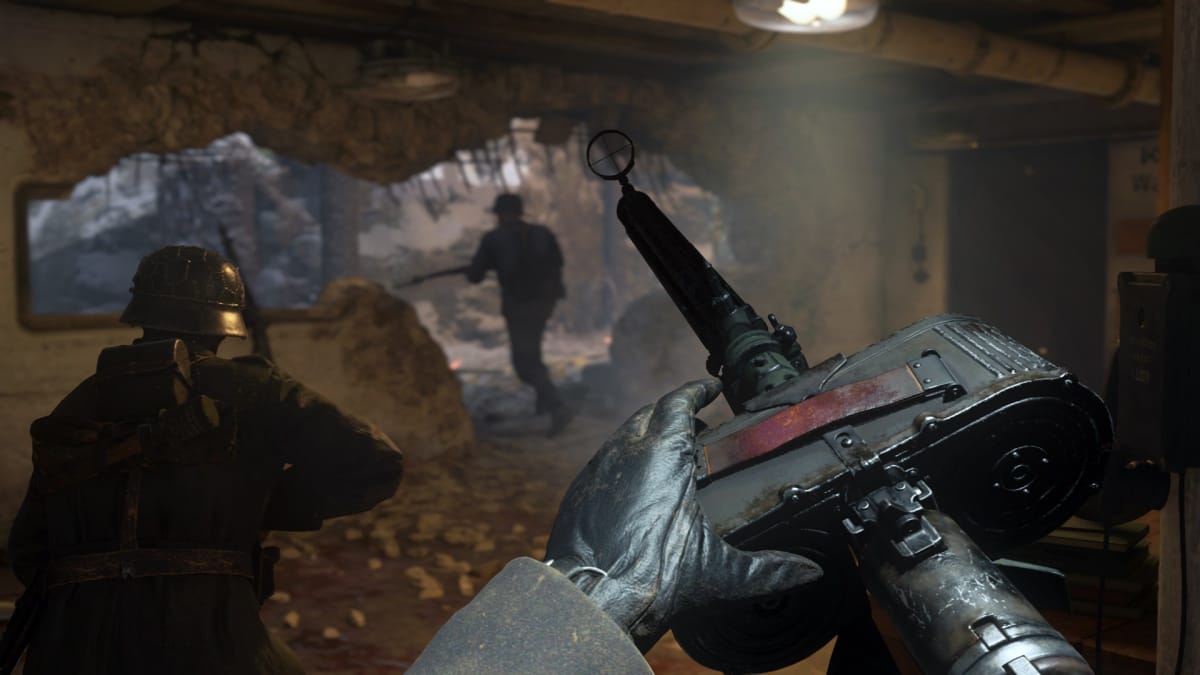 An in-engine screenshot of Call of Duty: WWII, showcasing a trio of soldiers preparing to advance, with a POV shot of a soldier reloading their weapon.