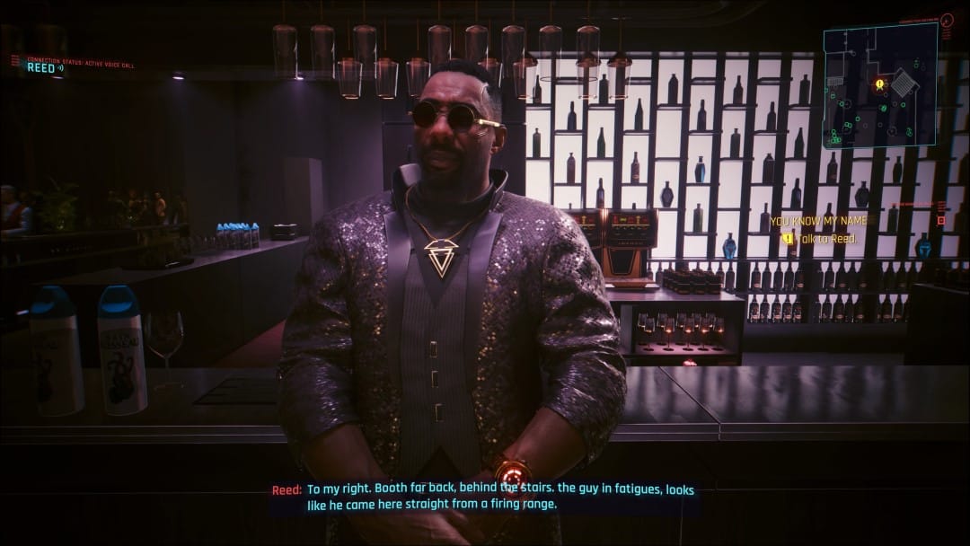 A screenshot from Cyberpunk 2077 Phantom Liberty showing V and Solomon Reed at a fancy dinner party, exchanging tactical information