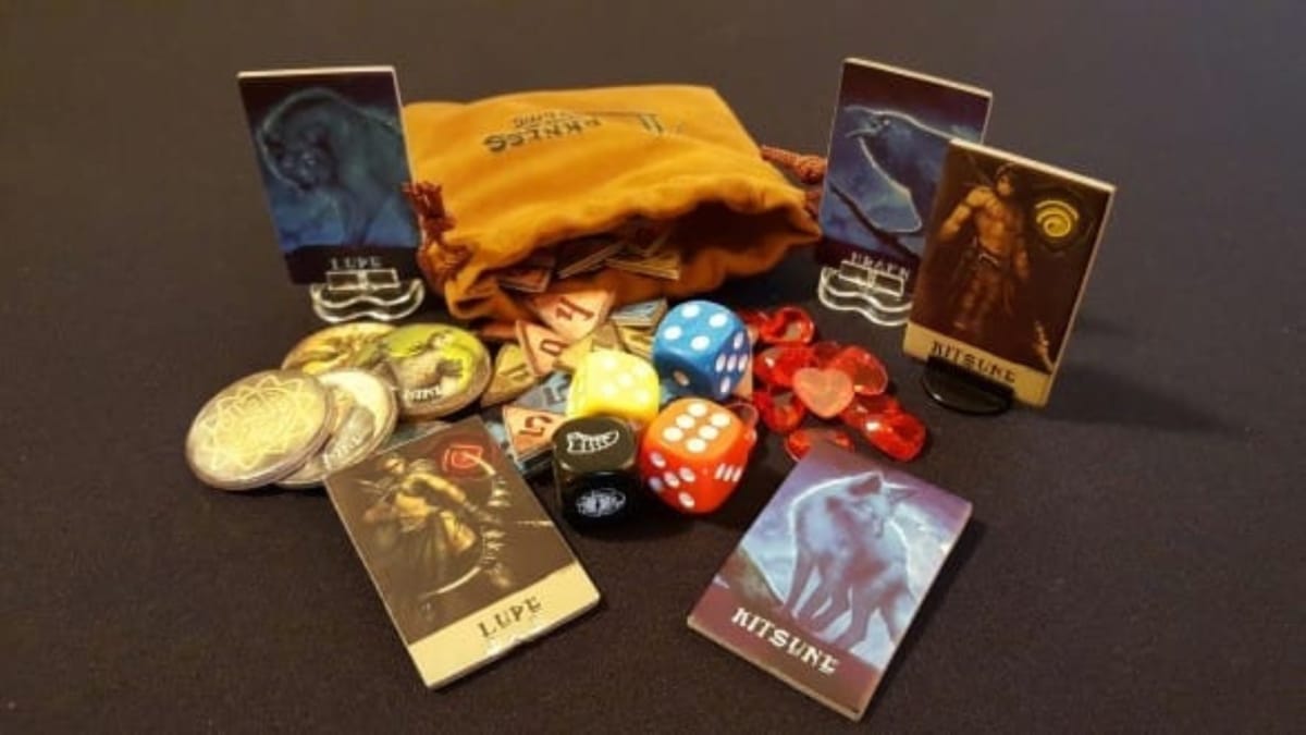 Darkness Comes Rattling photo of varios game pieces die and tokens lying in a pile on a black surface with a yellow-brown cloth bag nearby