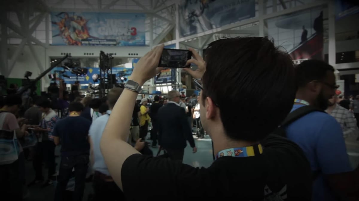 Someone holding up a phone camera to film an E3 event