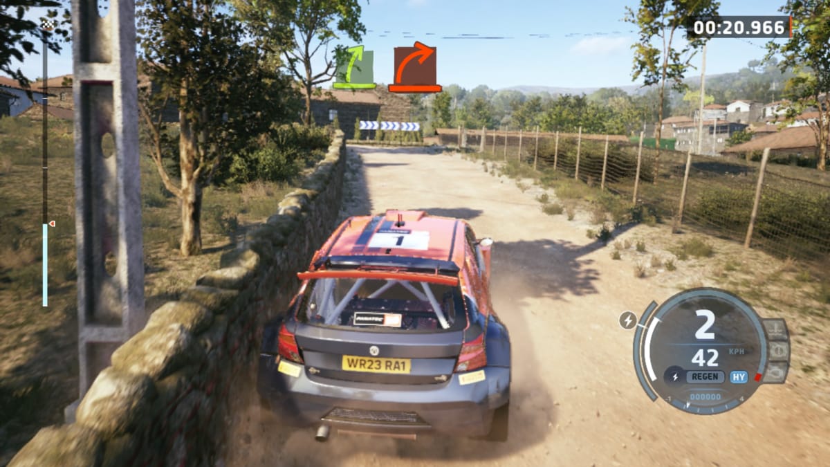 EA Sports WRC screenshot showing a red car kicking up dust and skidding into a wall 