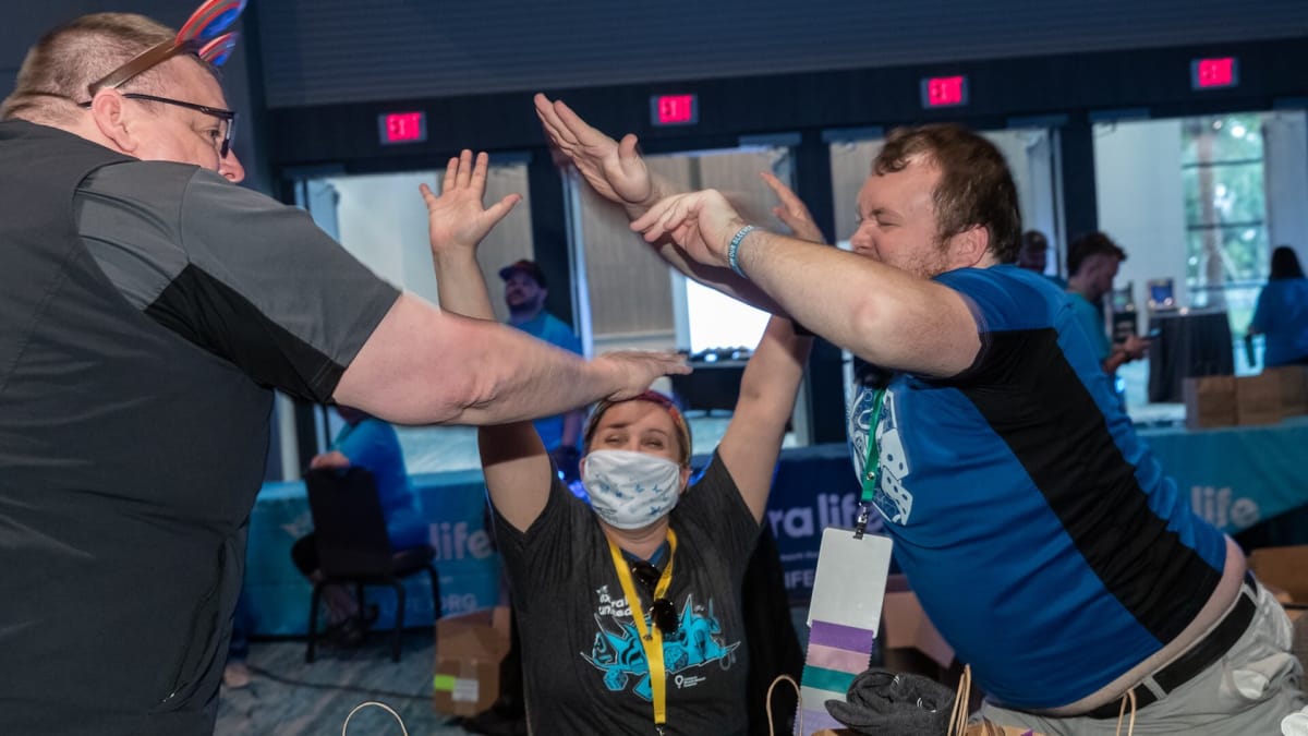 Three people celebrating the Extra Life gaming charity (in an image that is not from E3 2016, but is representative of the charity as a whole)