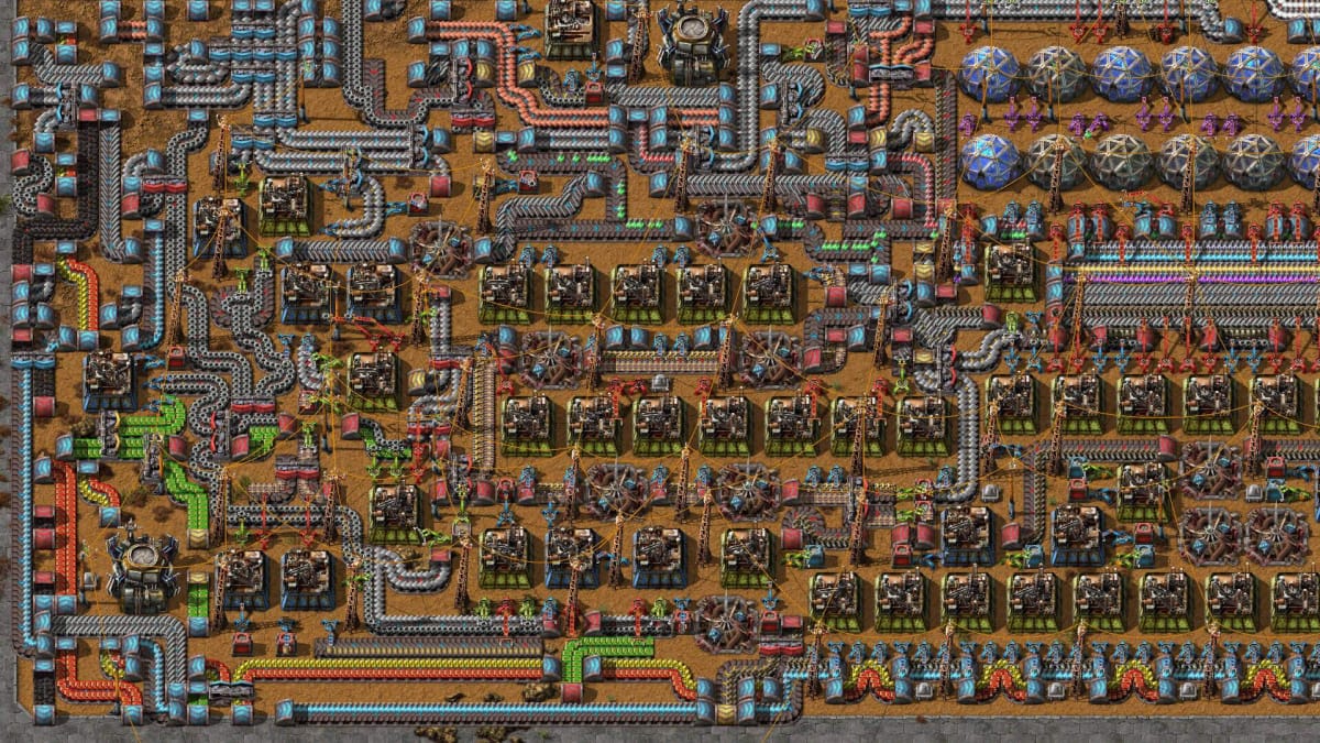 An extremely complex series of buildings, conveyor belts, and other factory elements in Factorio