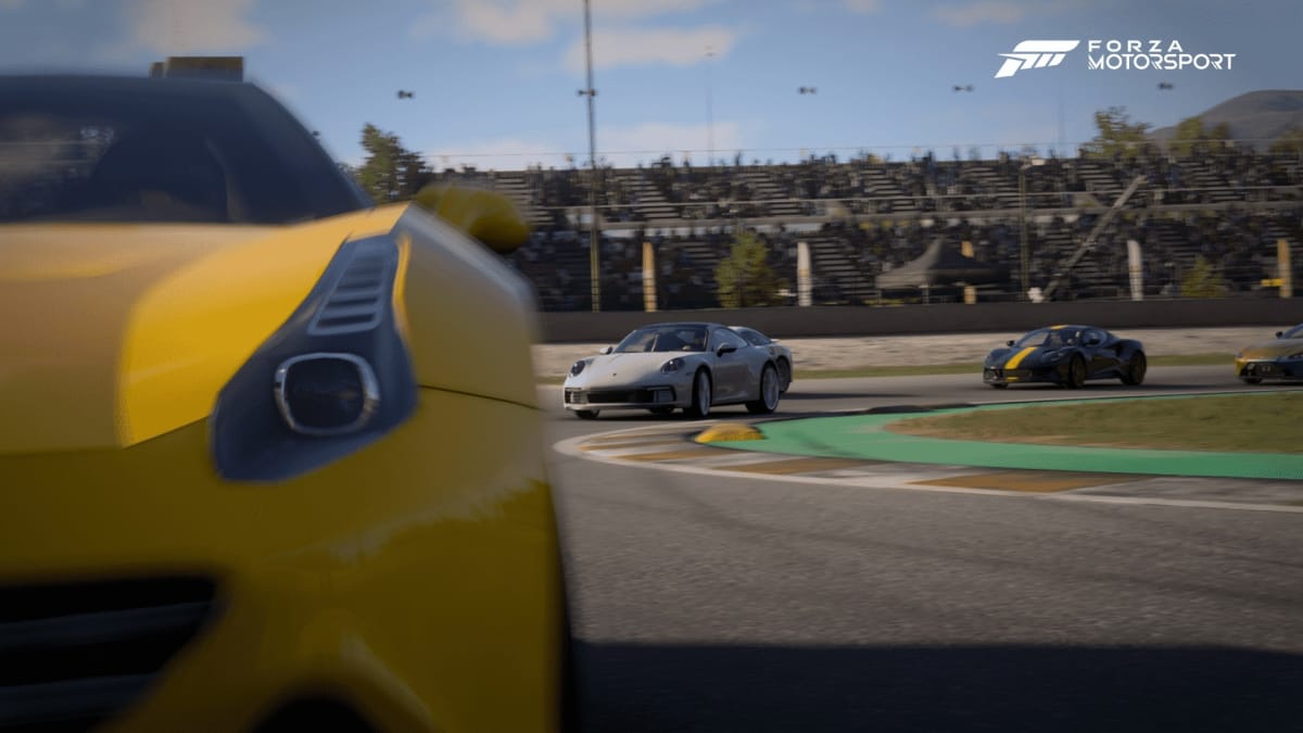 An in-game screenshot of Forza Motorsport, showcasing a yellow Porsche in front of a white Porsche on the turn, with a clear blue sky above them.