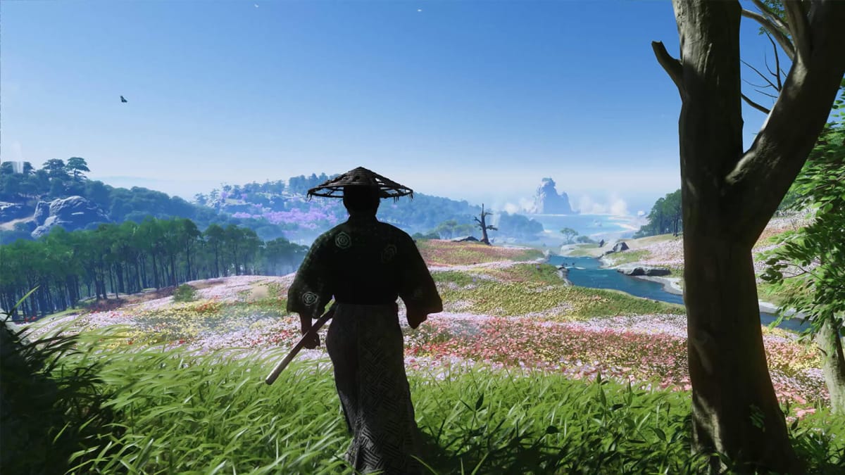 Jin strolling through a flower field in Ghost of Tsushima