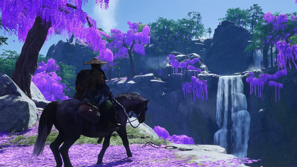 Jin riding his horse in a purple flower field in Ghost of Tsushima
