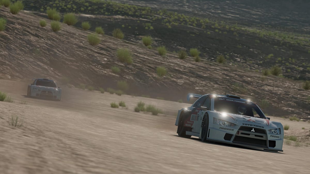 Two cars racing on a dirt track in Gran Turismo Sport