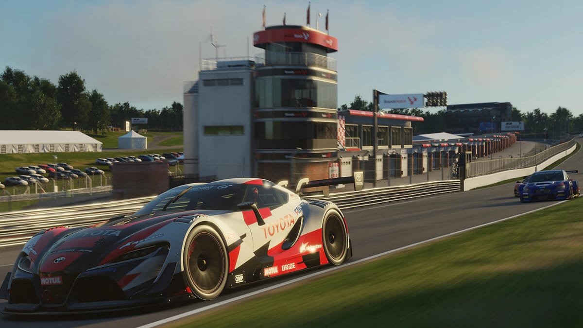 Two cars racing on a track in Gran Turismo Sport