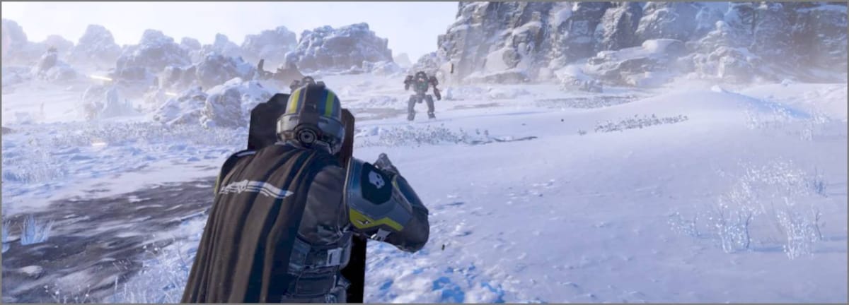A Helldiver protecting himself with the Ballistic Shield Backpack while fighting Automatons on a frozen planet in Helldivers 2