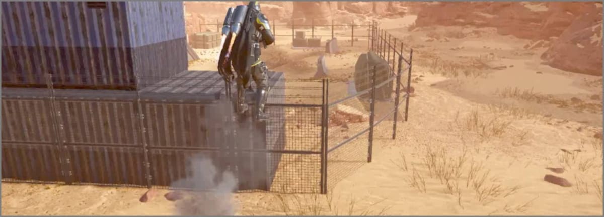 A Helldiver using the Jump Pack to leap over a fence and shipping containers in Helldivers 2