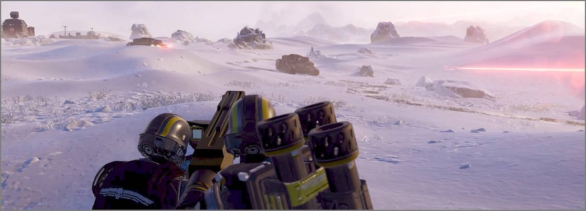 Two Helldivers team-firing the Spear on an icy planet in Helldivers 2