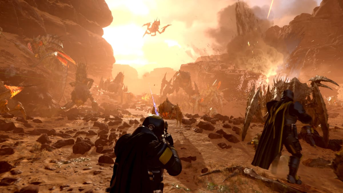 A group of soldiers engaged in pitched battle with insects in a rocky desert environment in Helldivers 2