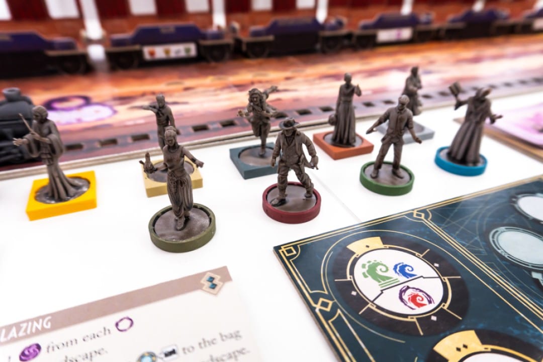 A screenshot of miniatures and game pieces of investigators from Horror on the Orient Express: The Board Game