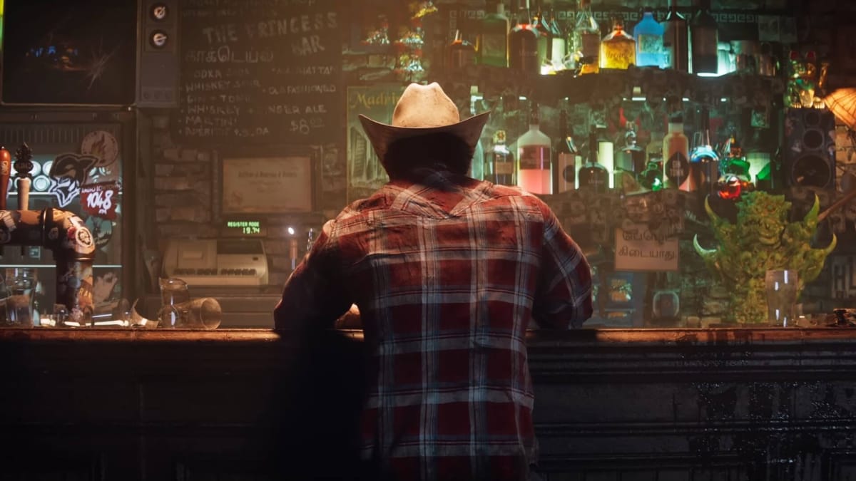 A rear view of Wolverine in a hat sitting at a bar in the upcoming Insomniac Games Wolverine title