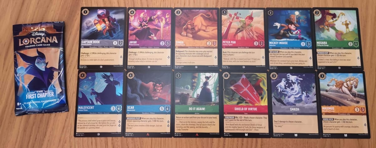 The 12 Disney Lorcana Cards in our First Chapter Booster Pack 15.
