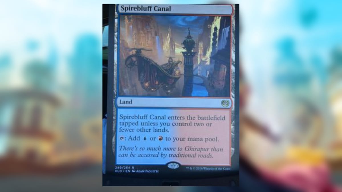magic the gathering card in blue and red with art depicting a huge canal with towering buildings on either side