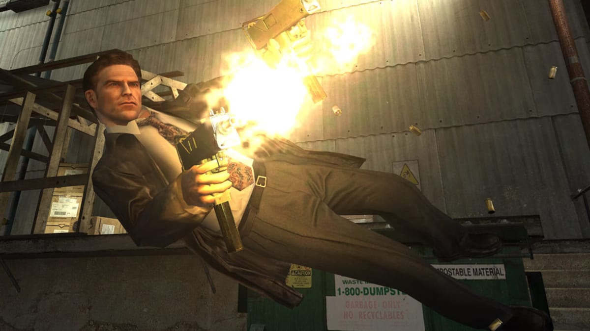 Max Payne leaping sideways and firing dual machine guns in a warehouse in Max Payne 2, which is being remade as one of Remedy's upcoming Max Payne remakes