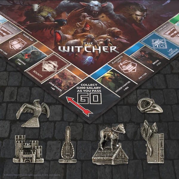A screenshot of collectible tokens from Monopoly: The Witcher. The tokens include Kaer Mohren, Roach on a Roof, a lute, a flaming book, and a crystal bird skull 