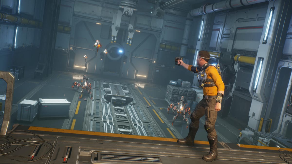Cutter Slade aiming at robotic enemies in a warehouse in Outcast: A New Beginning