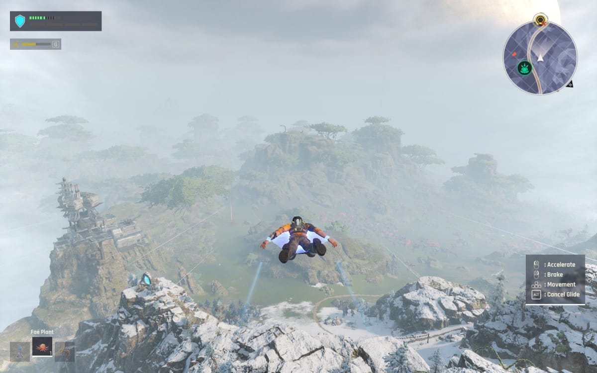 Outcast a New Beginning screenshot showing a man in an orange top gliding over some snow capped mountains with a structure to his left