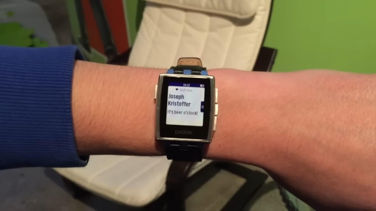 Someone wearing a Pebble smartwatch displaying a notification