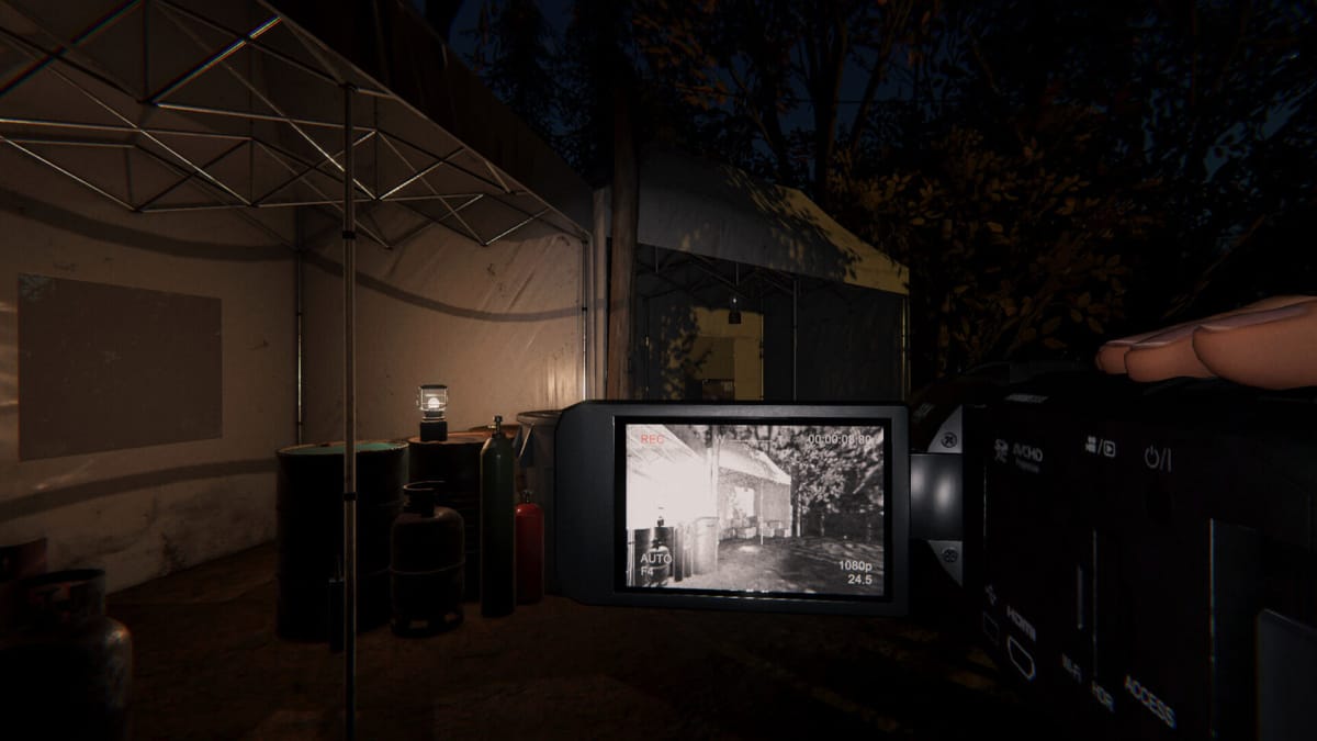 The player viewing a dark outdoor environment through a camera in Phasmophobia