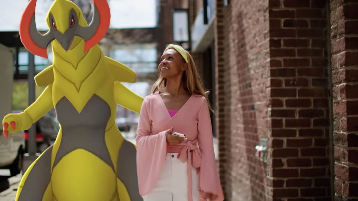 Haxorus standing behind a woman in a Pokemon Go trailer