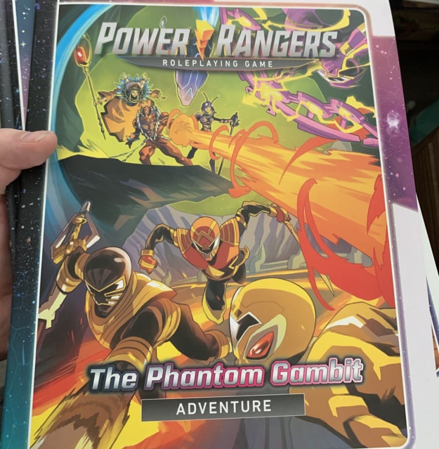 The cover of The Phantom Gambit adventure book, showing a team of Power Rangers avoiding a blast of fire from an enemy monster