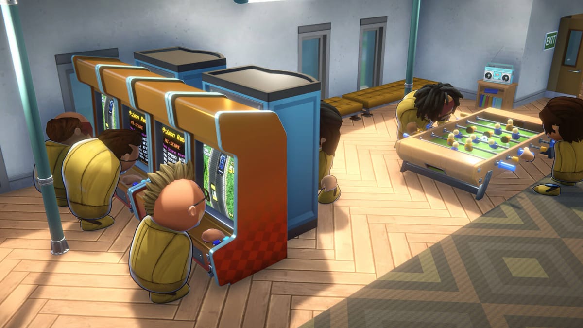 Prisoners engaging in recreation, some on arcade machines and some on a foosball table, in Prison Architect 2